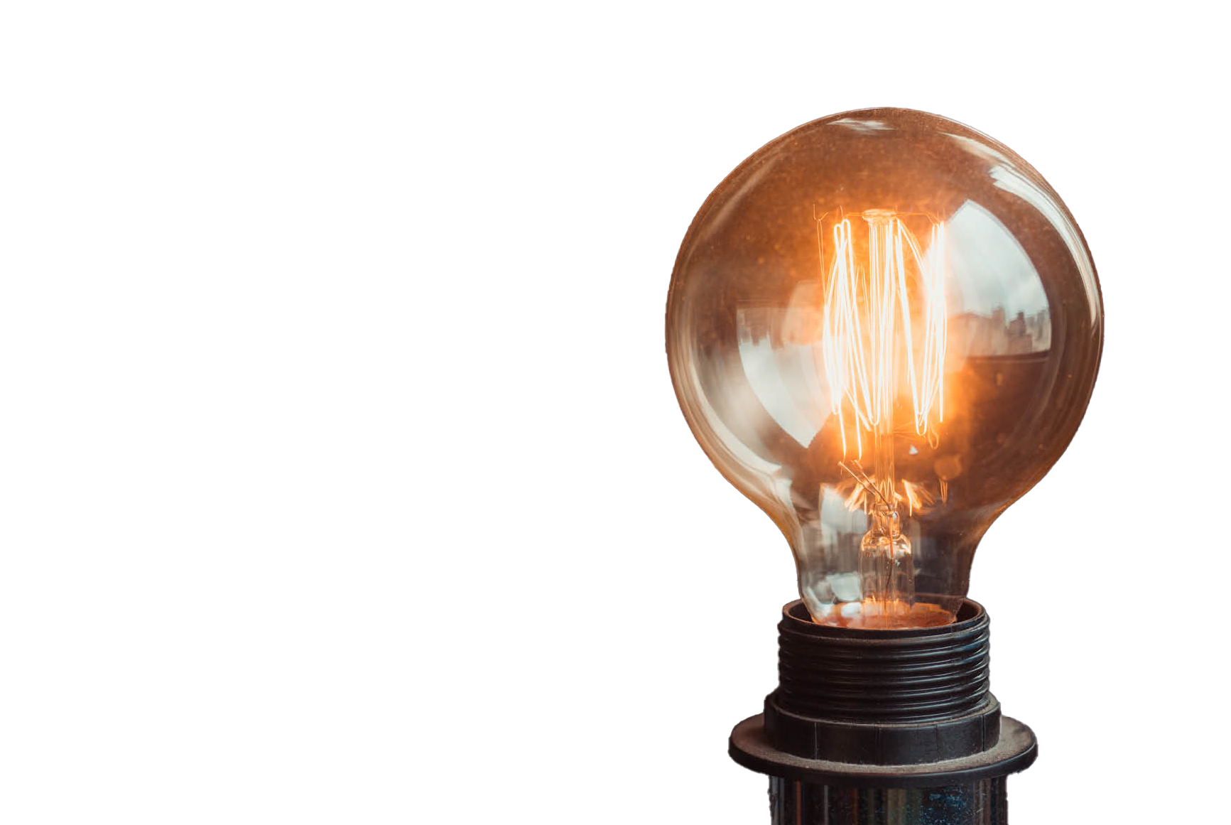 A light bulb is glowing, emitting warm light against a black background.